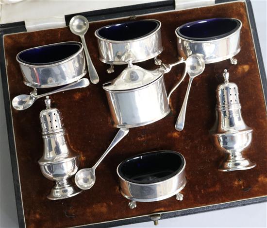 A cased George V silver seven piece condiment set by Walker & Hall, Birmingham, 1926.